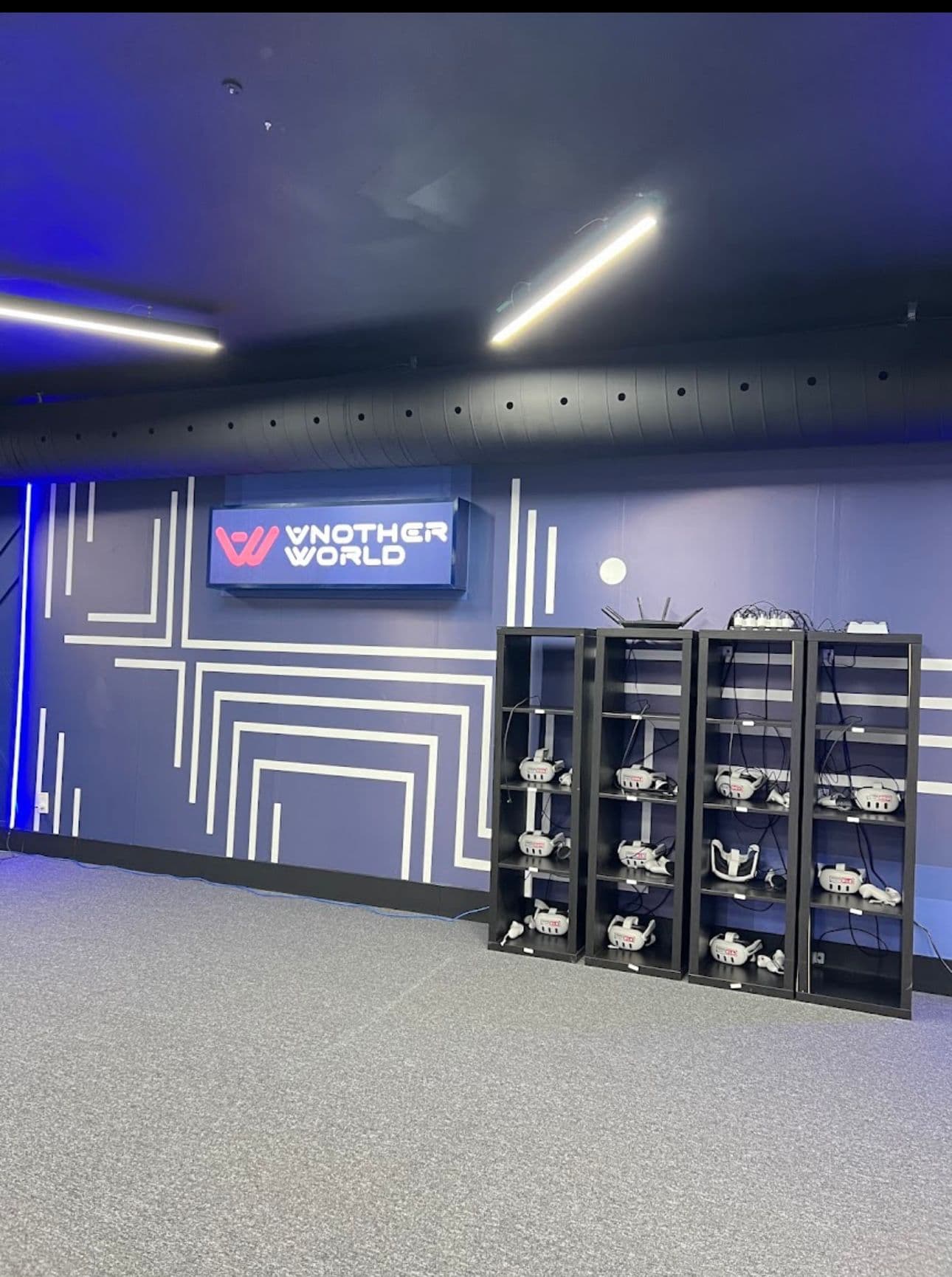 Wall of charged VR headsets ready for play