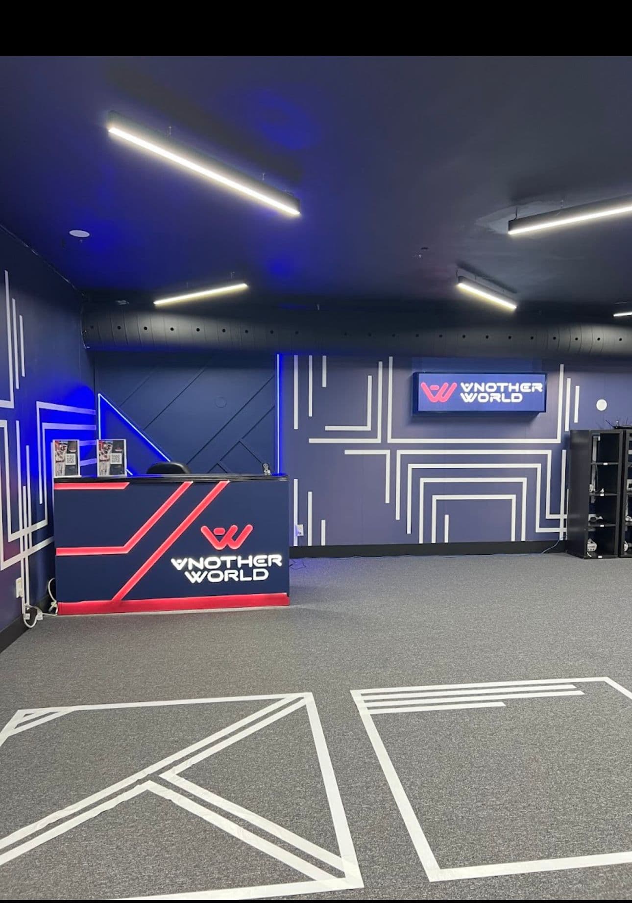 The Another World reception desk with W-logo signage